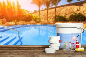 Equipment with chemical cleaning products and tools for the maintenance of the swimming pool. photo