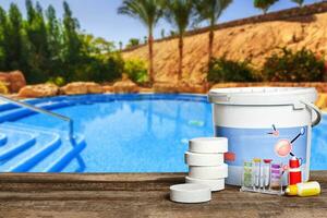 Equipment with chemical cleaning products and tools for the maintenance of the swimming pool. photo