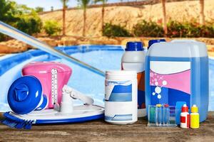 Equipment with chemical cleaning products and tools for the maintenance of the swimming pool. photo