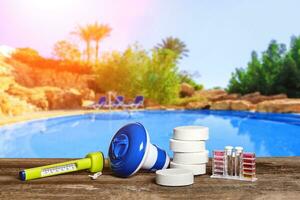 Equipment with chemical cleaning products and tools for the maintenance of the swimming pool. photo