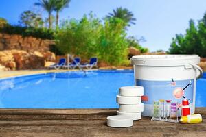 Equipment with chemical cleaning products and tools for the maintenance of the swimming pool. photo