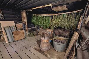 Dried herbs and branches on wooden background of ancient bathhouse photo