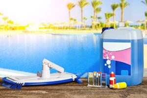 Equipment with chemical cleaning products and tools for the maintenance of the swimming pool. photo