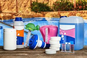 Equipment with chemical cleaning products and tools for the maintenance of the swimming pool. photo