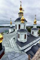 Eastern orthodox crosses on gold domes, cupolas, against blue sky with clouds photo