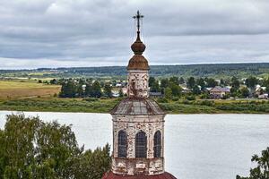 Eastern orthodox crosses on gold domes, cupolas, against blue sky with clouds photo