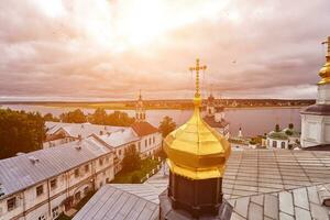 Eastern orthodox crosses on gold domes, cupolas, against blue sky with clouds photo