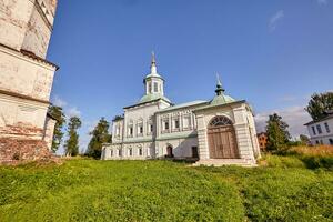 Old orthodox church at village. Summer view with floral meadow. photo