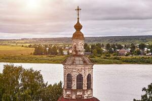 Eastern orthodox crosses on gold domes, cupolas, against blue sky with clouds photo