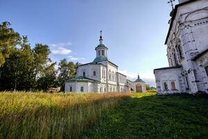 Old orthodox church at village. Summer view with floral meadow. photo