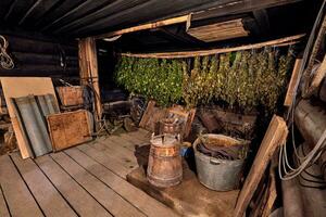 Dried herbs and branches on wooden background of ancient bathhouse photo