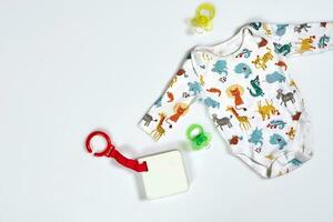 Baby care accessories and clothing on white background, top view photo