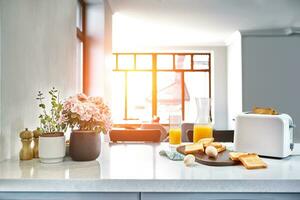 Portion of toasts on a wooden board with orange juice. Breakfast is served on a table with light blue napkin. photo