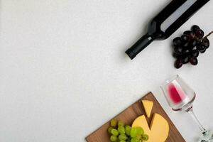 Wine, glasses and corkscrew over white background. Top view photo