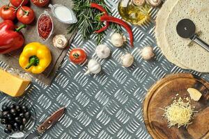 Cheese, different vegetables on metal table. Ingredients for traditional italian pizza. photo