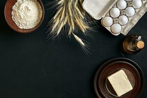 Dough preparation recipe bread, pizza or pie making ingredients, food flat lay on kitchen table background. Working with butter, yeast, flour, eggs, oil. Pastry or bakery cooking. photo