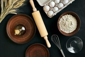 Dough preparation recipe bread, pizza or pie making ingredients, food flat lay on kitchen table background. Working with butter, yeast, flour, eggs, sugar. Pastry or bakery cooking. photo