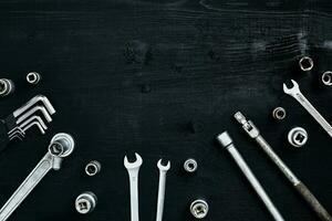 Tools for work or repair auto on black wooden background. Top view photo