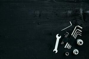 Tools for work or repair auto on black wooden background. Top view photo