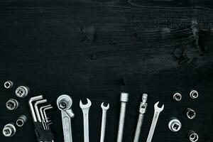 Tools for work or repair auto on black wooden background. Top view photo