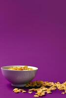 Bowl with cornflakes on the colorful background photo