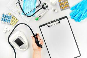 Close-up of tonometer by patients arm during blood pressure measuring at medical consultation photo