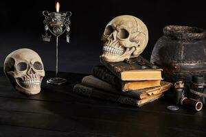 Realistic model of a human skull with teeth on a wooden dark table, black background. Medical science or Halloween horror concept. Close-up shot. photo