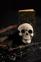 Realistic model of a human skull with teeth on a wooden dark table, black background. Medical science or Halloween horror concept. Close-up shot. photo