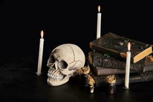 Realistic model of a human skull with teeth on a wooden dark table, black background. Medical science or Halloween horror concept. Close-up shot. photo