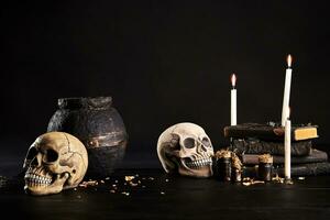 Realistic model of a human skull with teeth on a wooden dark table, black background. Medical science or Halloween horror concept. Close-up shot. photo