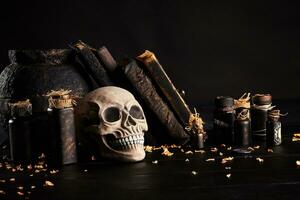 Realistic model of a human skull with teeth on a wooden dark table, black background. Medical science or Halloween horror concept. Close-up shot. photo