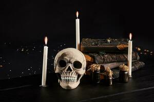 Realistic model of a human skull with teeth on a wooden dark table, black background. Medical science or Halloween horror concept. Close-up shot. photo