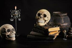 Realistic model of a human skull with teeth on a wooden dark table, black background. Medical science or Halloween horror concept. Close-up shot. photo