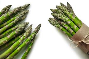 An edible, raw stems of asparagus isolated on white background. photo