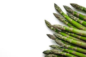 An edible, raw stems of asparagus isolated on white background. photo