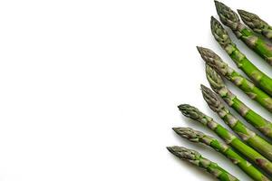 An edible, raw stems of asparagus isolated on white background. photo
