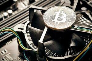 Bitcoin. New virtual money. Bitcoins lie on the video card, concept of mining. photo