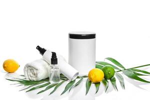 White bottles and two whole lemon and lime isolated on white background. The concept for advertising cosmetics photo