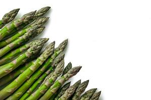 An edible, raw stems of asparagus isolated on white background. photo