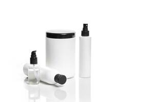 Set of cosmetic products in white containers on light background. photo