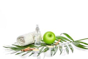 Natural spa beauty treatment cleansing products with apple on white background. photo