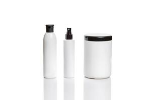 Set of cosmetic products in white containers on light background. photo