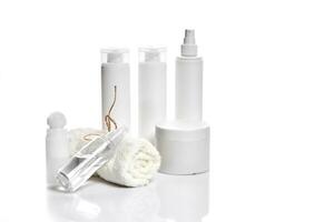 Set of cosmetic products in white containers on light background. photo