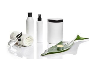 Set of cosmetic products in white containers on light background. photo