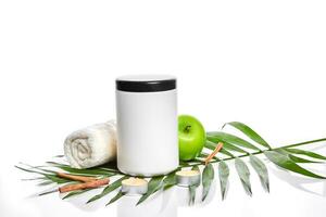 Natural spa beauty treatment cleansing products with apple on white background. photo