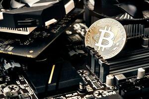 Bitcoin. New virtual money. Bitcoins lie on the video card, concept of mining. photo