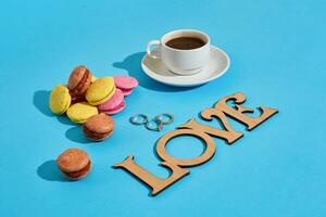 Tasty sweet macarons and coffee cup. Macaroons on blue backgroun photo