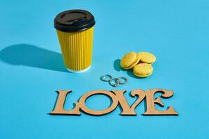 Tasty sweet macarons and coffee cup. Macaroons on blue backgroun photo