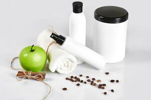 Natural spa beauty treatment cleansing products with apple on white background. photo