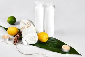 White bottles and two whole lemon and lime isolated on white background. The concept for advertising cosmetics photo